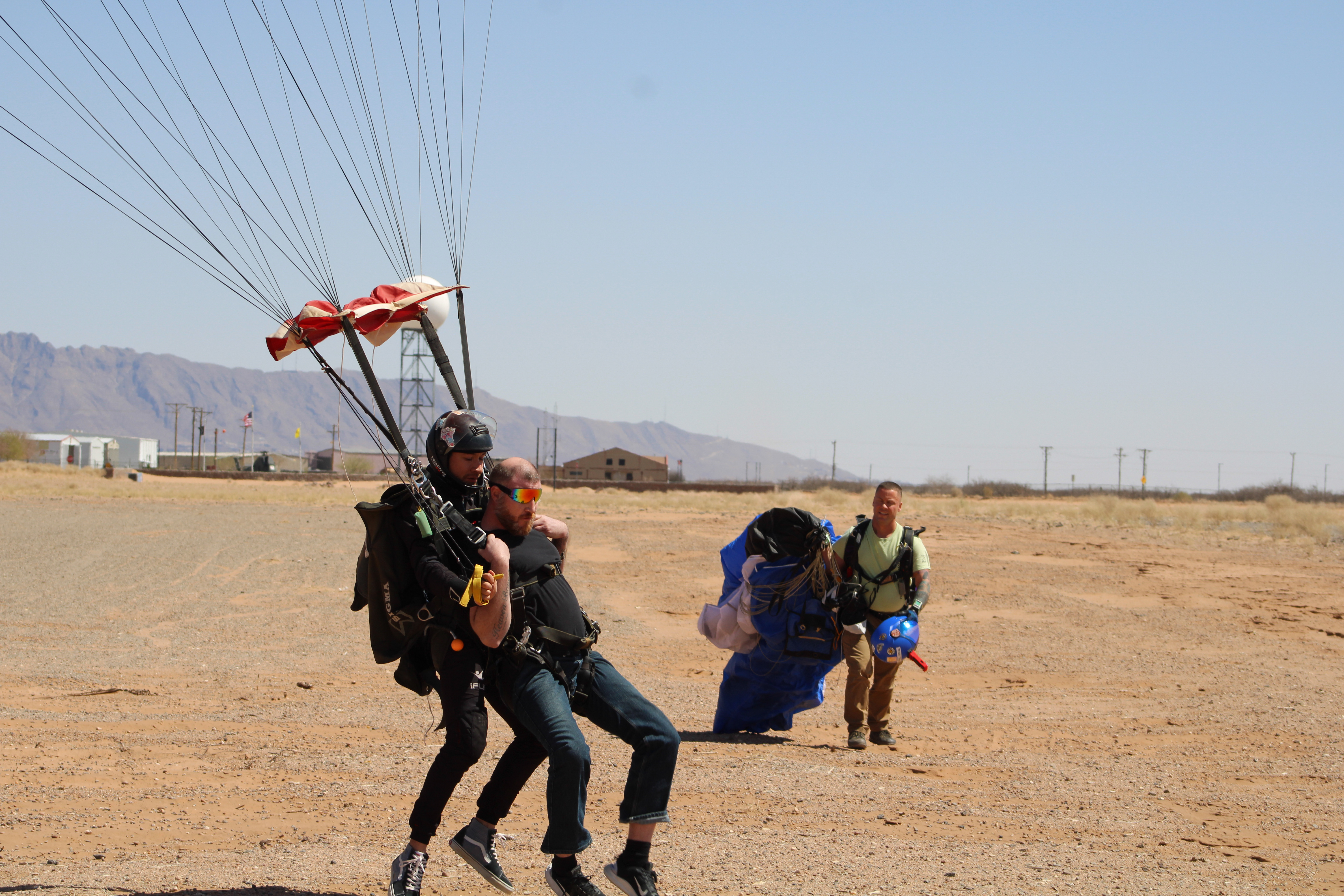 Tandem student exiting aircraft with instructor